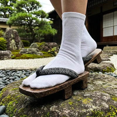 Close-up of navy hanao strap with white seigaiha wave pattern on geta sandals