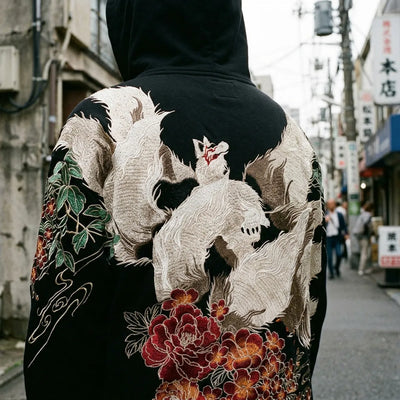 Close view of the nine-tailed fox embroidery on the back of the hoodie, white fur threads and a red mask