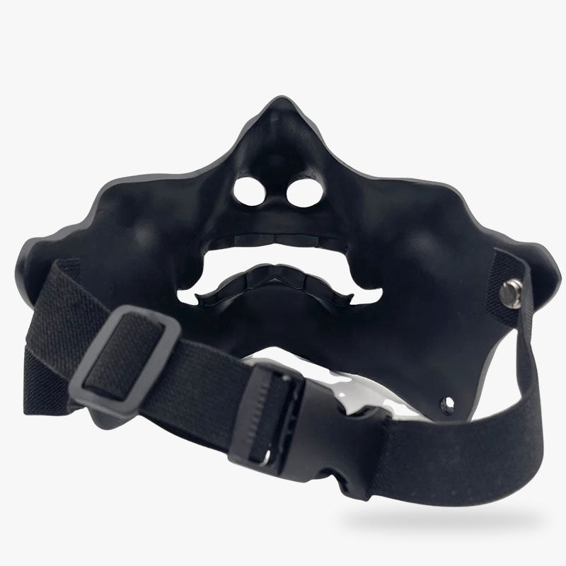 the ninja with oni mask hold the black oni mask with straps