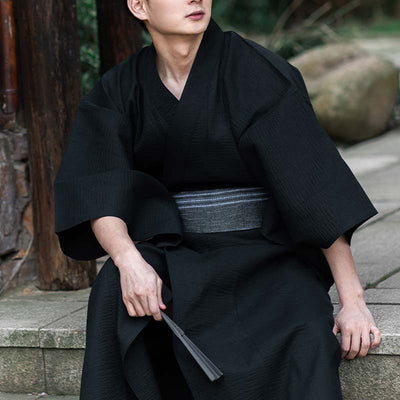 a man is dressed with a black kimono and a japanese belt obi grey made with cotton materia