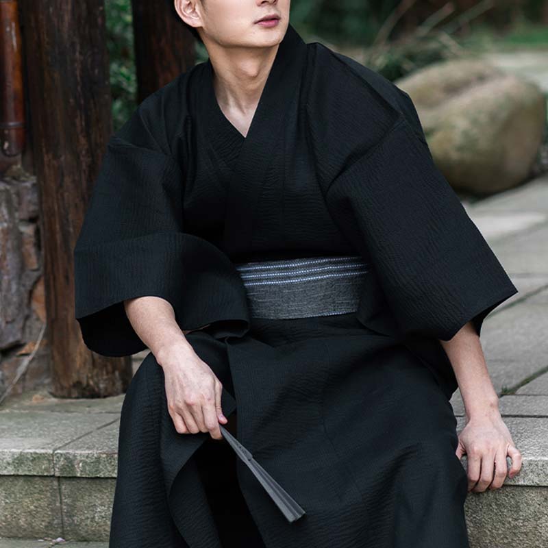 a man is dressed with a black kimono and a japanese belt obi grey made with cotton materia
