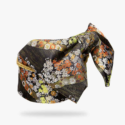 This obi kimono belt is a geisha accessory that closes the Japanese kimono. The obi belt is dark red and embroidered with japanese floral patterns