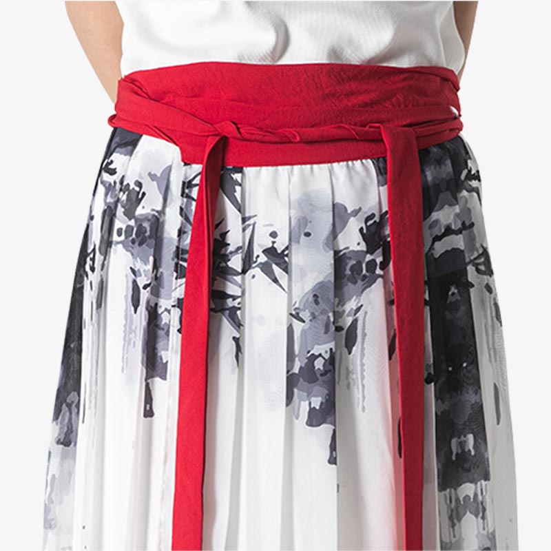 These Japanese dress ties with a Japanese obi skirt. They are traditional Japanese trousers with a red obi belt and nature-inspired painting motifs.