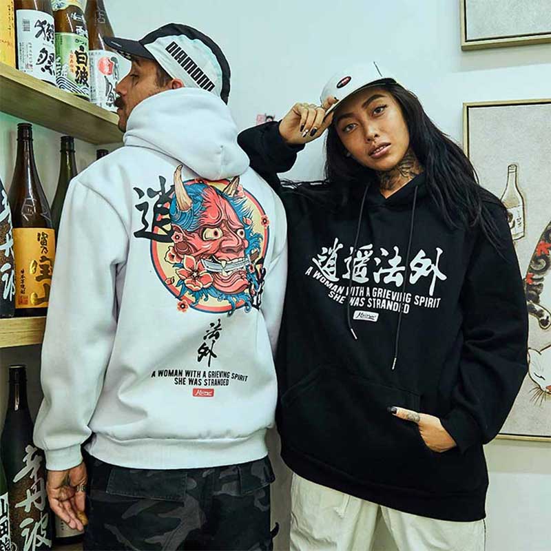 a man and a girl are dressed with oni demon hoodie. White and black colors for the japanese hodie. Design printed on cotton material are Kanj and japanese face demon from irezumi tattoo art