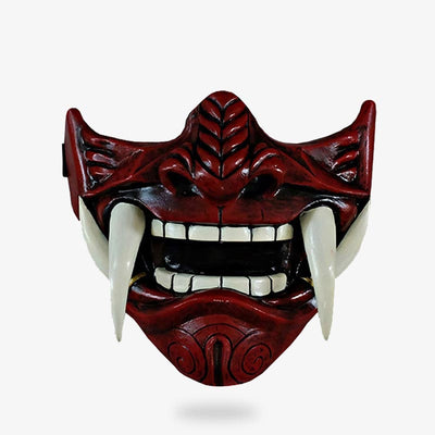 This oni half mask is called a mempo mask. It represents the face of a Japanese demon with teeth.