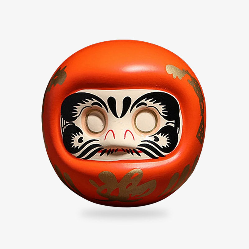 Orange Daruma symbolizing energy and motivation, traditionally used in Japan to inspire enthusiasm and drive