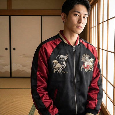 Man wearing a black and red souvenir jacket with embroidered japanese designs in a traditional washitsu room.