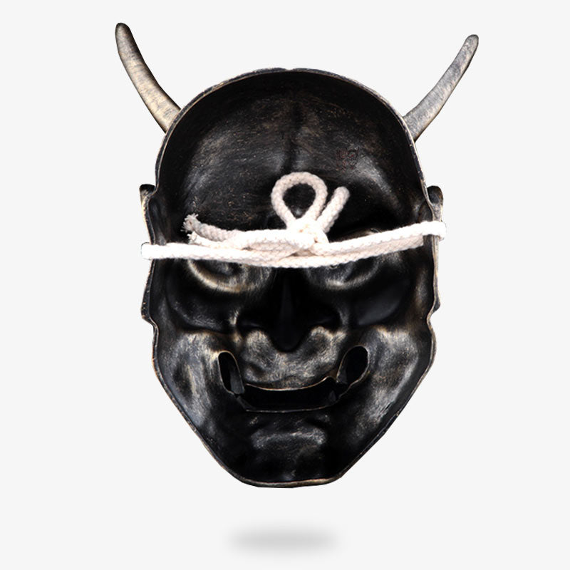 This red traditional Japanese mask is attached to the head with a white cord.