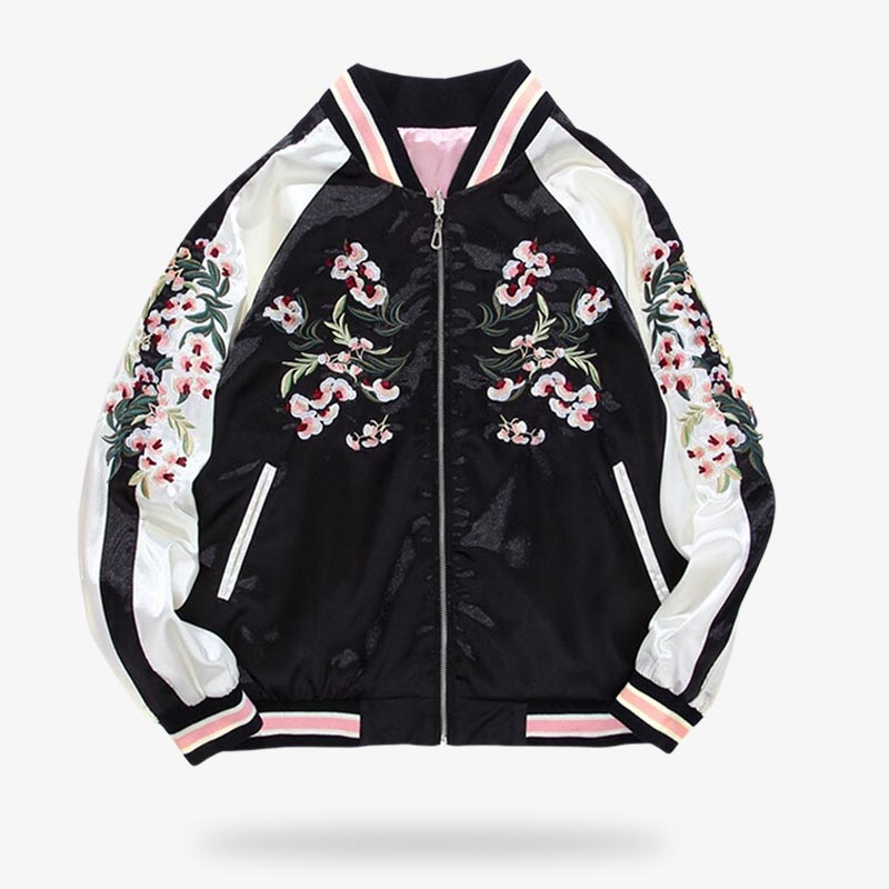 This black and white reversible souvenir jacket is a Japanese women's bomber that closes with a zipper. The jacket's floral motifs are embroidered