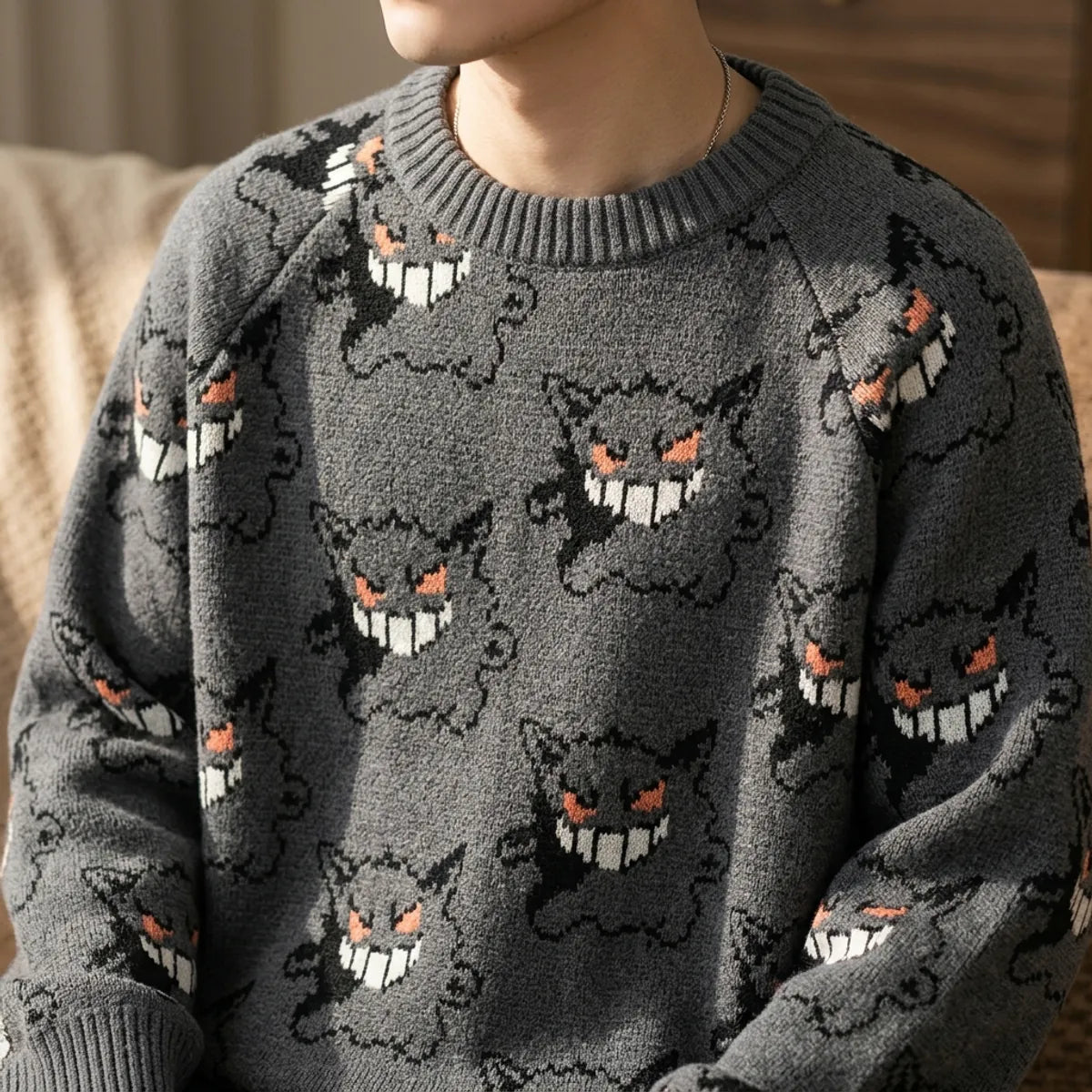 Side slit ribbed hem detail on a gray Gengar print sweatshirt with straight boxy cut