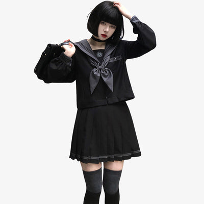 a girl is dressed with a black sailor uniform japanese. The full set is black japanese schoolgirl shirt, long student socks, a japanese student ribbon and a black schoolgirt shirt