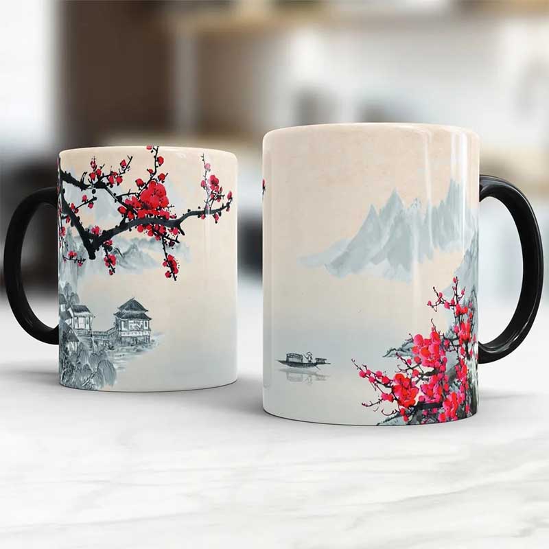 These sakura coffee mugs showcase an elegant design of cherry blossoms and a traditional Japanese village, perfect for enjoying your coffee with a touch of cultural elegance.