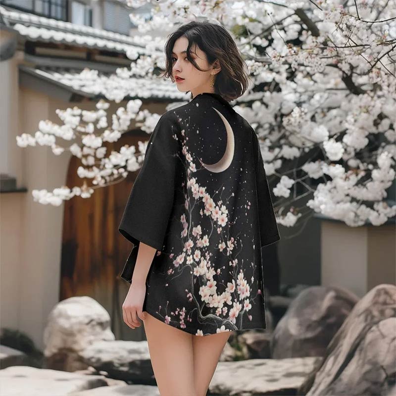 a woman is dressed with Sakura kimono pattern showcasing refined cherry blossom motifs and moon symbol pprinted. Those traditional motifs are popular in traditional Japanese textile design and culture.