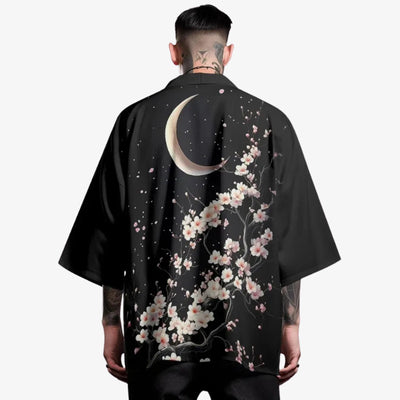 A man is dressed with a Moon kimono featuring subtle lunar motifs and sakura flowers printed, blending celestial elegance with traditional Japanese fashion.