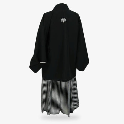 Sendaihira fabric featured in the striped hakama pants worn with a black Japanese kimono and haori jacket, blending durability and cultural authenticity.