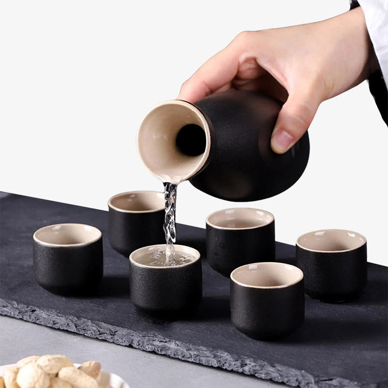 Traditional set sake featuring a black ceramic sake bottle and six sake cups, crafted to elevate the Japanese sake-drinking experience with authentic ceramic material and black colored style