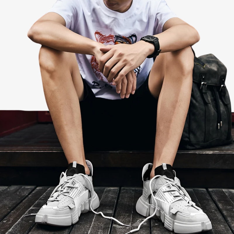 A man wears Streetwear japanese sneakers. Thoses Shoes Harajuku inspired by Tokyo’s vibrant street fashion scene, offering playful and edgy footwear. Grey colored japanese shoes for casual outfit