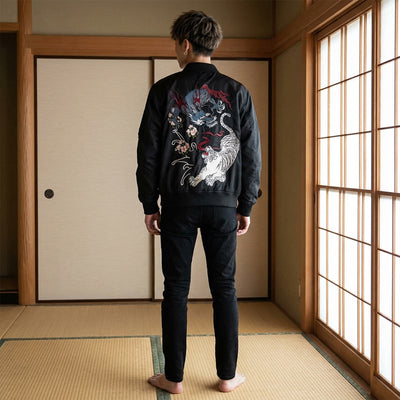 Man wearing a black souvenir jacket with a white tiger design in a traditional Japanese room.