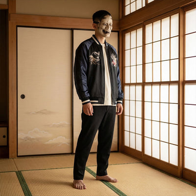 Person wearing a black and blue souvenir jacket outfit with embroidery design in a traditional Japanese washitsu room.