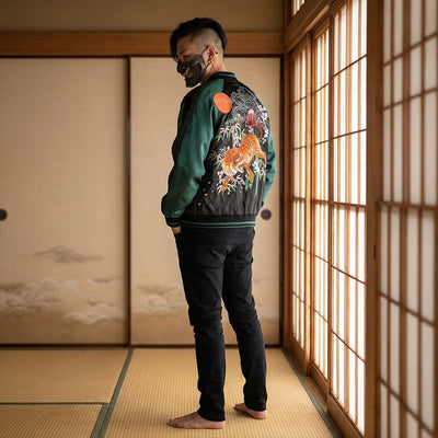 Person wearing a sukajan jacket green with a tiger design in a traditional Japanese room.