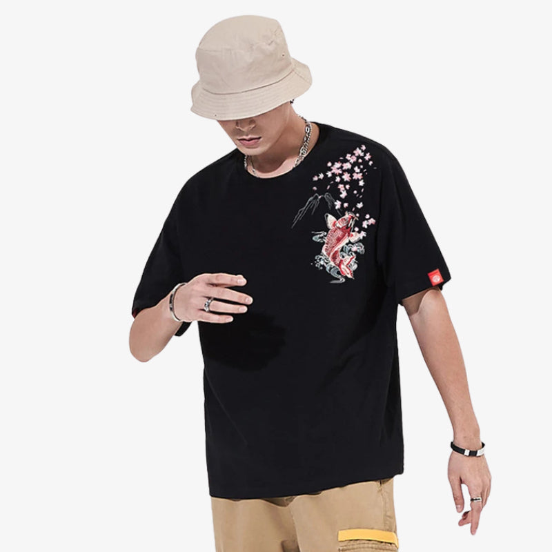 Person wearing a black t-shirt Koi with a colorful graphic Japanese gish design on a white background