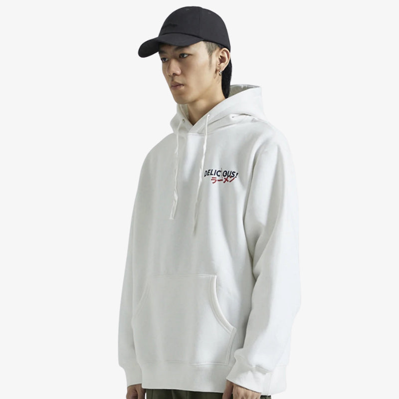 Person wearing a white Tokyo hoodie men with text and a black cap on a white background