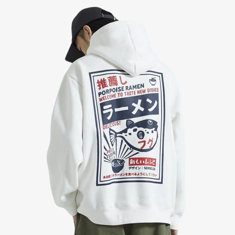 Person wearing a white Tokyo hoodie with a graphic design on the back, featuring text and a fish illustration.