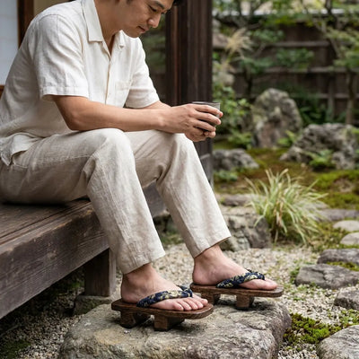 Tong Japan Geta worn with white tabi socks on a garden path