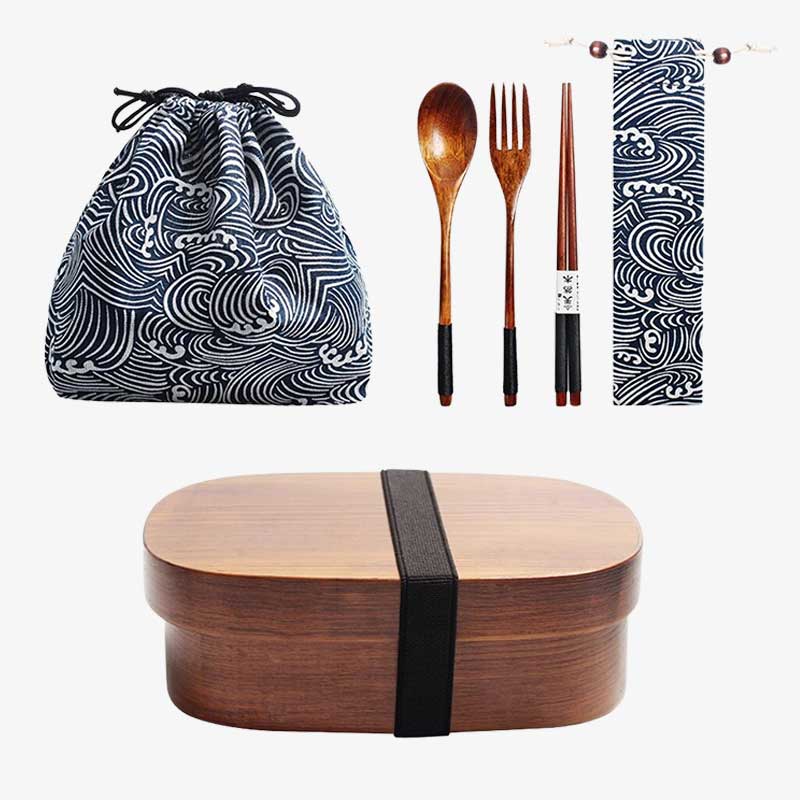 A Traditional Bento Box with black strap, patterned drawstring bag, wooden cutlery set, and napkin on a white background