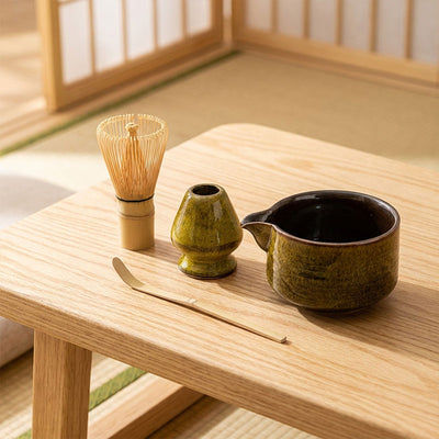 Ceramic tea-making set on a wooden table in a traditional Japanese room