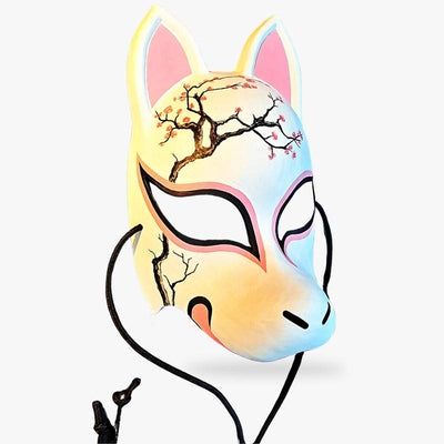 The traditional japanese kitsune mask is hand painted with a sakura flower tree. The japanese mask is a full face fox mask
