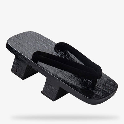 Array of black traditional Japanese sandals for a samurai or geisha outfits. The japaneese geta is black color with black strap.  It s the traditional japanese platform sandal