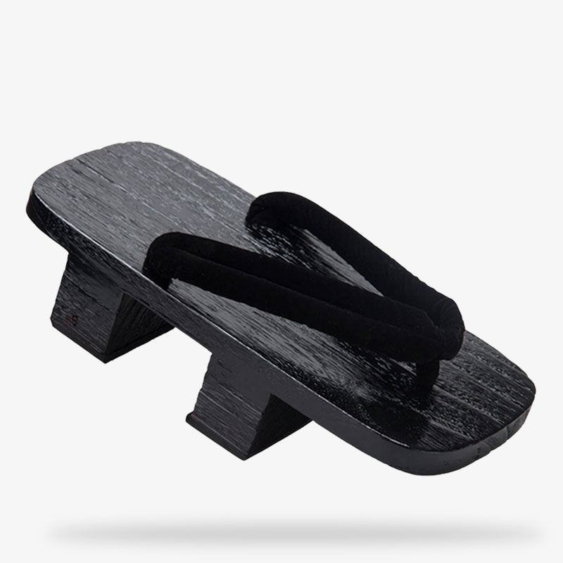 Array of black traditional Japanese sandals for a samurai or geisha outfits. The japaneese geta is black color with black strap.  It s the traditional japanese platform sandal