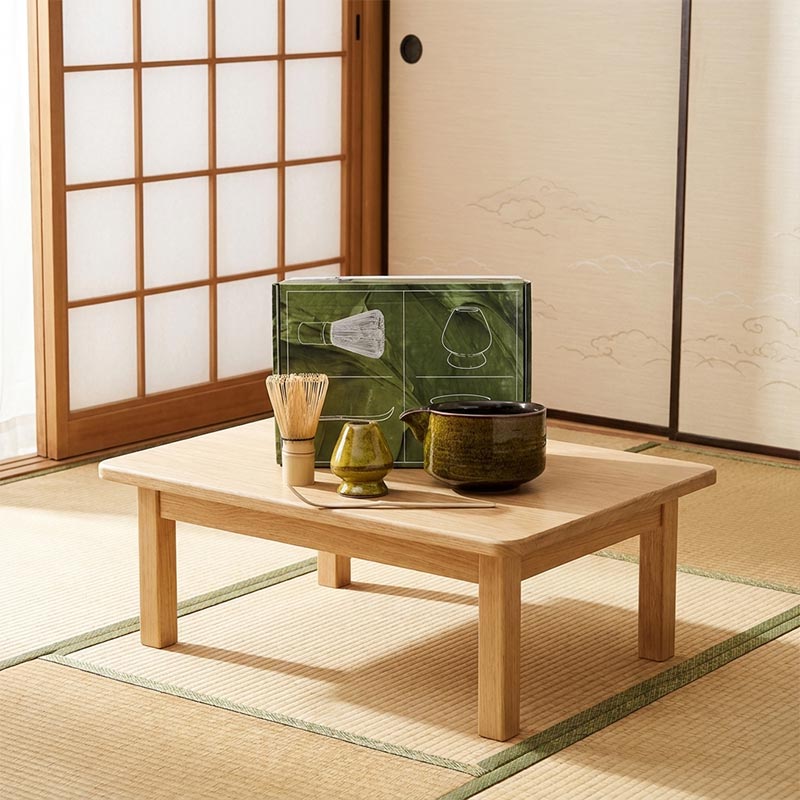a gold color Traditional Japanese tea set on a wooden table in a tatami room