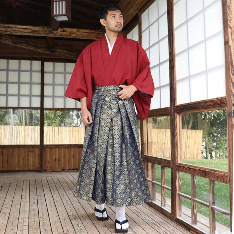 A Japanese man wears a traditional kimono male with a pair of geta sandals and white tabi socks.