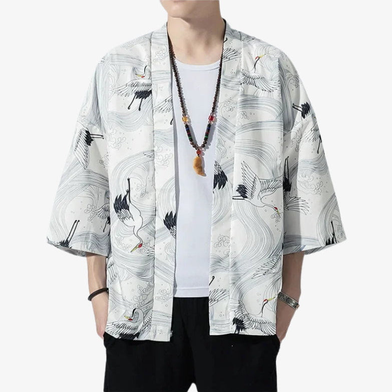 Person wearing a white haori kimono jacket style shirt with crane designs on a white background