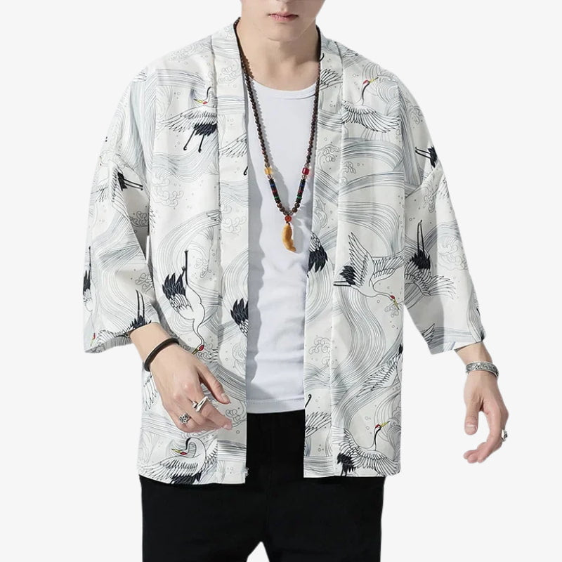 Person wearing a white kimono haori shirt with black japanese cranes patterns on a white background