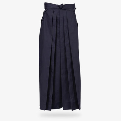 A person practicing Aikido wearing a traditional women blue Hakama pants  in navy blue
