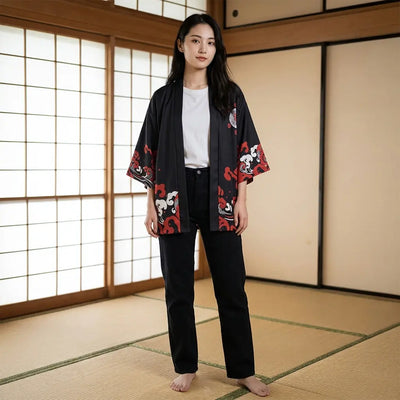 Woman wearing a haori black in a washitsu room with tatami and shoji screens