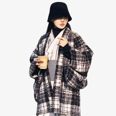 A person wearing a women kimono coat in a soft material fabric