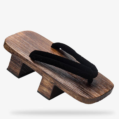 Elegant wooden Japanese sandals displayed on tatami, traditional and minimalist design. Black strap made with quality cotton and wood material for the japanese platform sandals. Wear it with a kimono