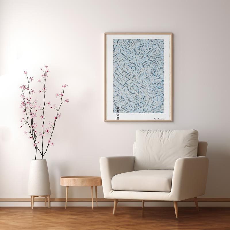 This yayoi kusama painting hold on a wall near to a sofa and small table. This abstract Japanese painting for a minimalist Japanese home decor design