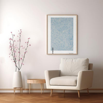 This yayoi kusama painting hold on a wall near to a sofa and small table. This abstract Japanese painting for a minimalist Japanese home decor design