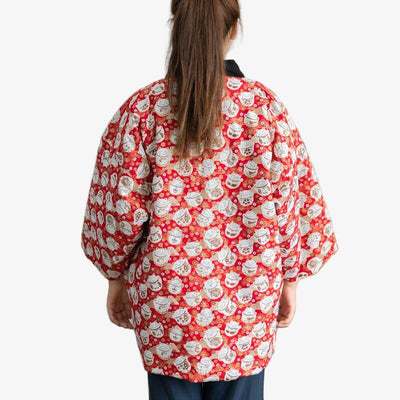 A woman is dressed with a Japanese coat Hanten Maneki neko with Japanese lucky cat pattern at the back