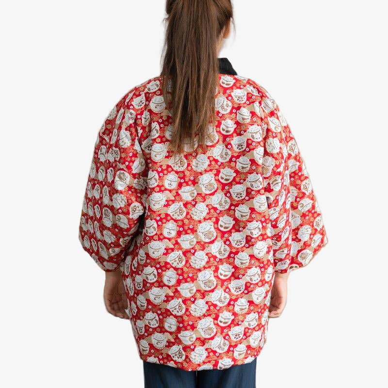 A woman is dressed with a Japanese coat Hanten Maneki neko with Japanese lucky cat pattern at the back