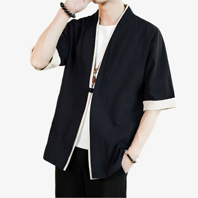 Person wearing a haori black kimono-style outfit in a living room setting