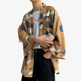A man is wearing a Japanese Haori Yukata. It's a men's kimono jacket that can be worn over traditional Japanese clothing. Or over a white T-shirt for a modern Japanese streetwear style.
