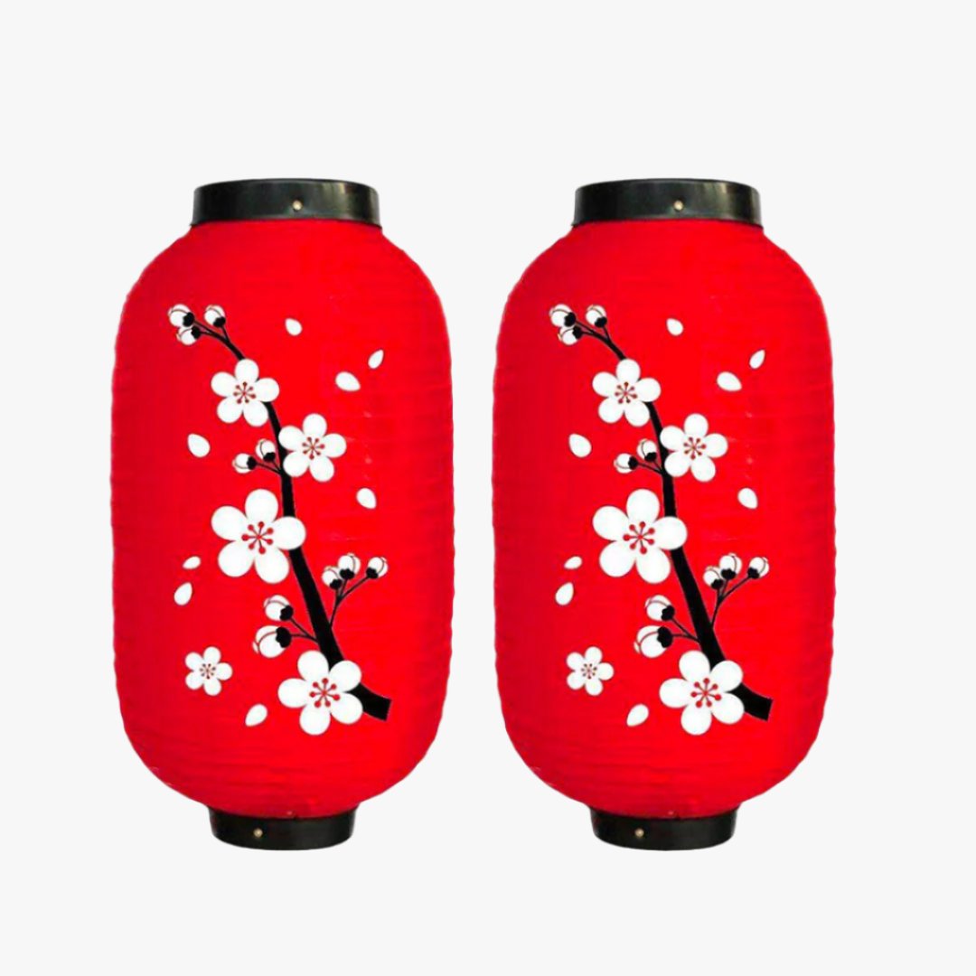 The Japanese lantern flower design is a Chochin paper lantern, adorned with floral patterns, ideal for adding a touch of nature to your japanese home decor. The lamps are red colored with white sakura cherry blossom flowers