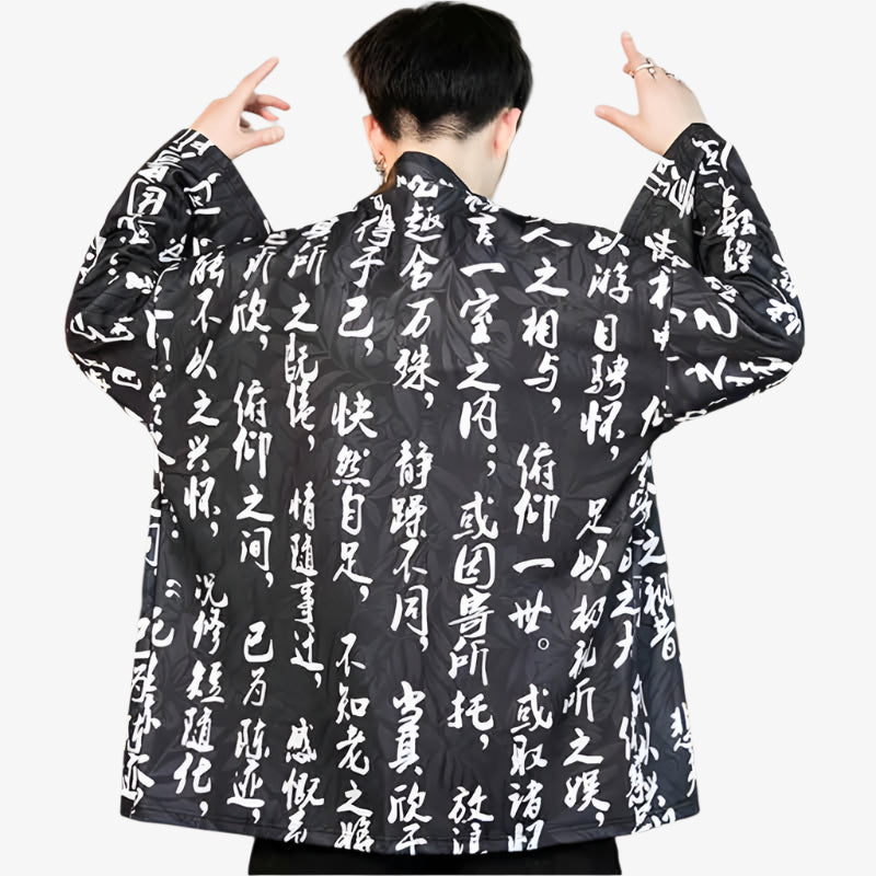 Person wearing a black japanese mens haori jacket​ with white kanji text patterns on a white background