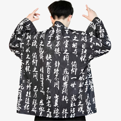 Person wearing a black japanese mens haori jacket​ with white kanji text patterns on a white background